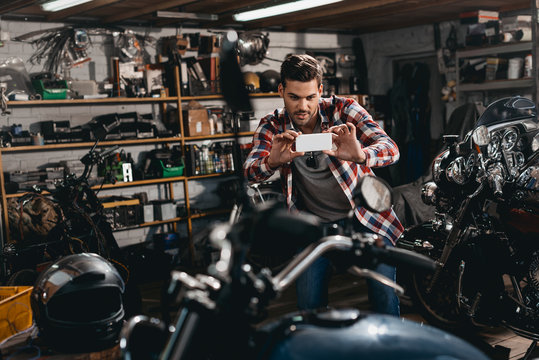 man taking photo of motorbike