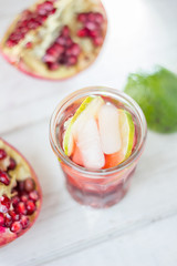 Top view of pomegranate lemonade with lime and ice