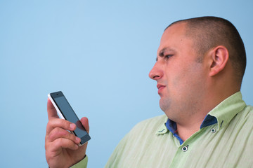 Man in green shirt with a smartphone.