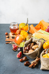 Fall autumn harvest thanksgiving background with pumpkin apple chestnut corn