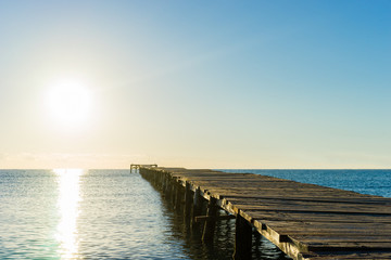 Obraz premium a wooden pier in the sun