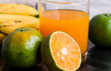 a glass of orange juice and fruit