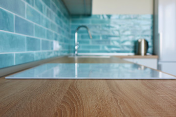 View of the kitchen brown countertop with white hob