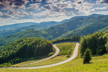 Fototapeta na wymiar Summer scenic view of mountains and road