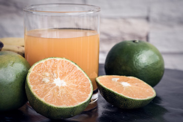 a glass of orange juice and fruit