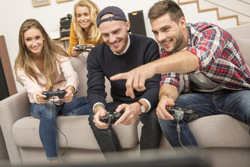 Young friends playing video games