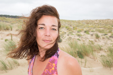 Outdoors lifestyle fashion portrait stunning girl on the beach