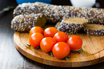 Hip of cherry tomatoes over the wooden board.