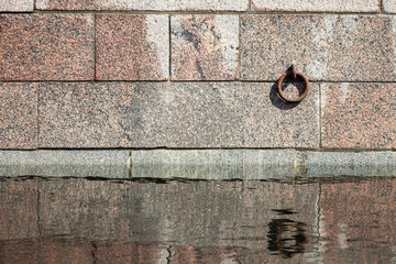 Mooring ring mounted in granite stone jetty wall