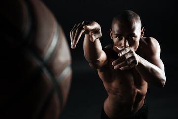 Fototapeta na wymiar Close-up photo of afro american basketball player throwing ball,
