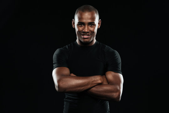 Smiling afro american sports man with arms folded looking at camera