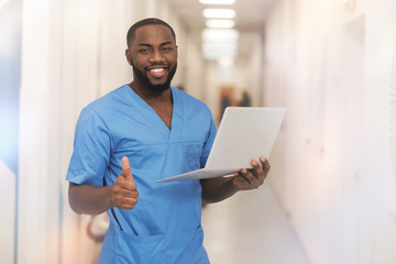 Attractive smiling man raising his thumb up