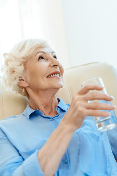 Elderly woman with glass of water