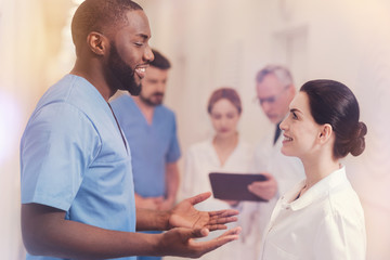 Profile picture of two medical workers while speaking