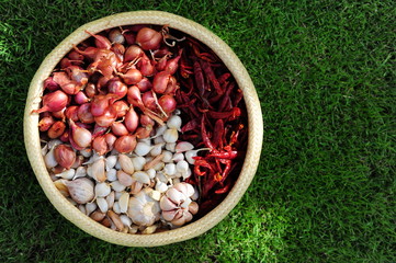 Thai cooking ingredients, garlic, onions, dried chilli in basket