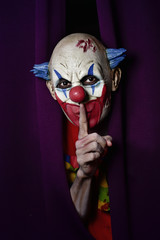 scary evil clown asking for silence