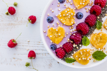 A bowl of healthy and delicious smoothie with grains and fresh berry fruit. 