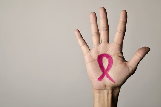 man with a pink ribbon for the breast cancer