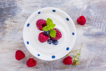 A bowl of healthy and delicious yogurt with fresh berry fruits. © iMarzi