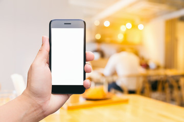 Man hand hold black mobile smart phone isolated white screen for advertising display with people sitting in coffee cafe background