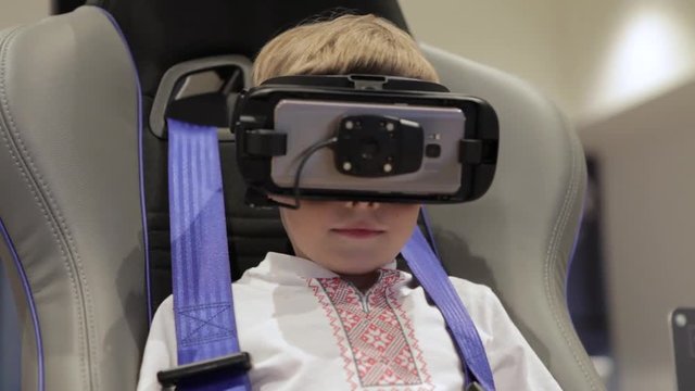 Little boy in virtual reality headset standing. Man wearing virtual reality goggles.