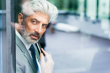 Mature businessman in the office looking out.