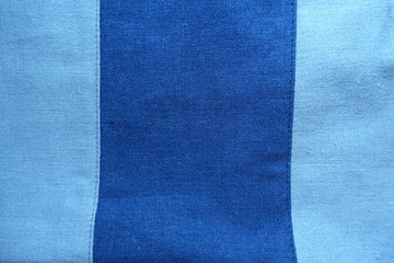 Fototapeta premium Wide dark stripe sewn to sky blue linen