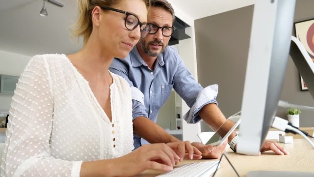 Business people working together on dektop computer