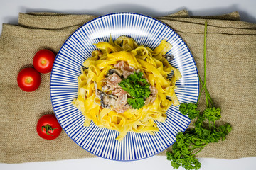 close-up of plate of pasta and chicken with lettuce