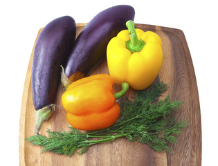 Sweet pepper, eggplant, parsley and fennel on a wooden tray..