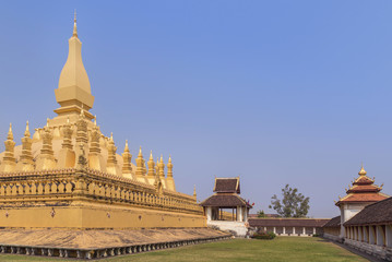 Fototapeta premium golden pagoda Phra That Luang public buddhist temple in Vientiane, Laos PDR under blue sky. 