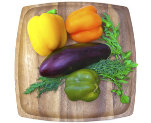 Sweet pepper, eggplant, parsley and fennel on a wooden tray..