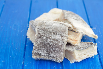 salted dry codfish on white wooden background