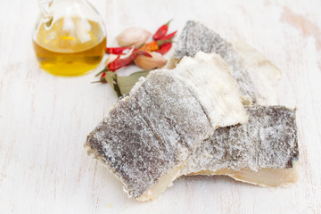 salted dry codfish on white wooden background