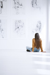 Woman looking at drawing collection
