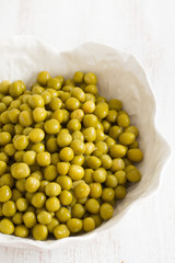 boiled peas on white bowl on white background