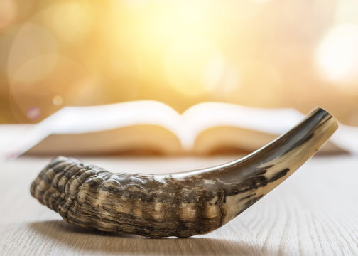 Yom Kippur And Rosh Hashanah (Hashana) Jewish New Year Holiday Concept With Ram Shofar (horn) With Religious Holy Prayer Book On Table