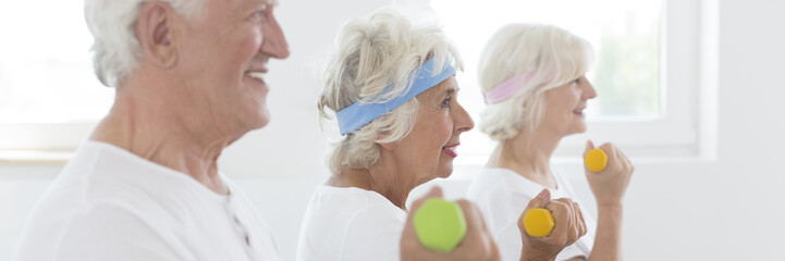 Active seniors lifting the dumbbells