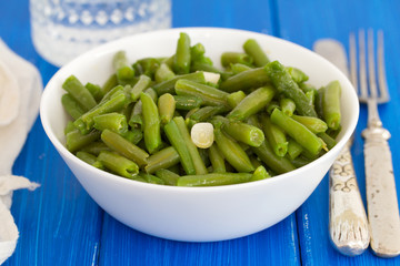 boiled green beans with garlic in white bowl