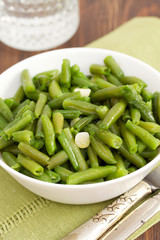 boiled green beans with garlic in white bowl