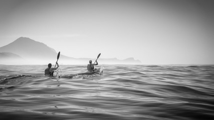 ocean kayak racers at dawn