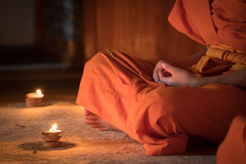 Novices monk vipassana meditation in front lighting candle - obrazy, fototapety, plakaty