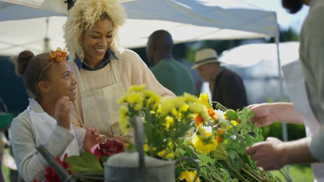  Mother & daughter working on a flower stall at the farmers market
