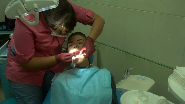young beautiful girl treats her teeth
