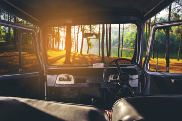 View on the dashboard of the car. Sunset view is in front of the car at Pang Ung in Mae Hong Son ,Thailand. - obrazy, fototapety, plakaty