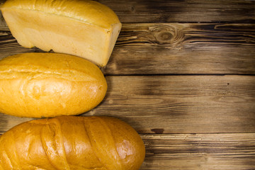 Assortment of baked bread on wooden table