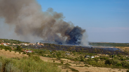 Fototapeta na wymiar Fire near small village