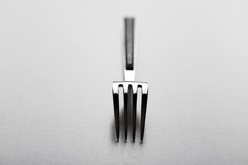 Close-up of fork design on gray background. Copy space.