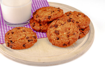 Chocolate biscuit on a checkered napkin with milk