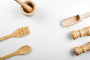 Wooden utensils for kitchen on white background. Copy space.